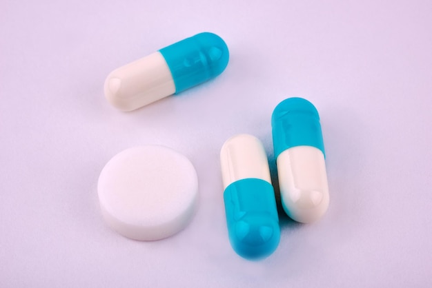 tablets and capsules with powder isolated on white background.