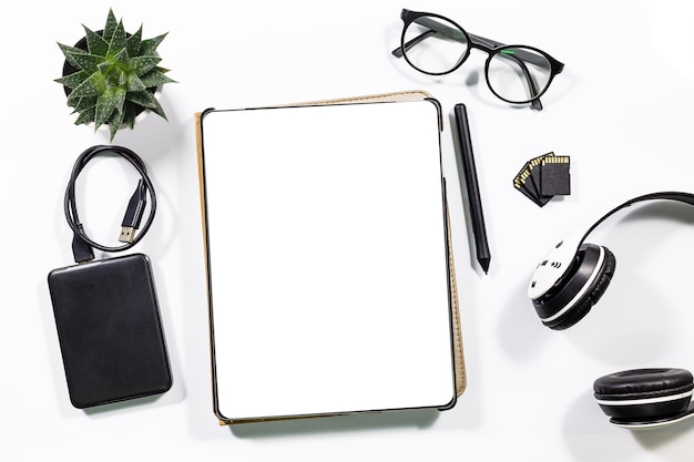 Tablets and envelopes are on the desk