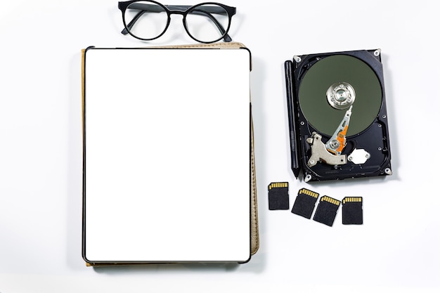 Tablets and envelopes are on the desk