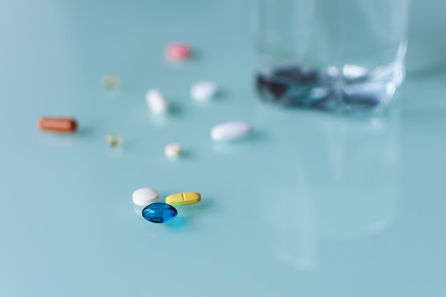 Tablets and a glass of water on the table