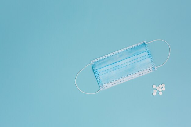 Tablets and mask on blue background