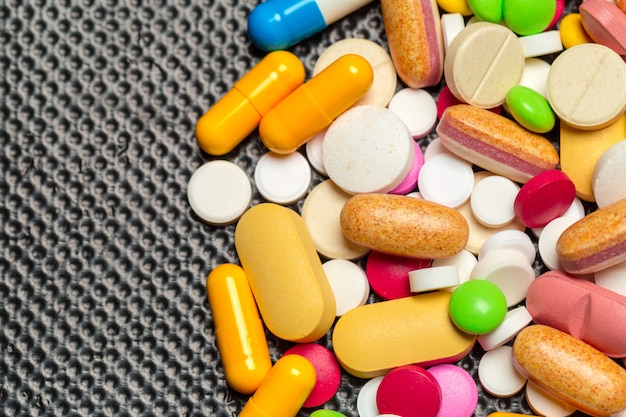 Tablets and pills on dark background