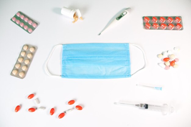 Tablets and a protective blue mask lie on a white background