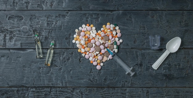 Tabletten injectiespuit en ampullen op een houten achtergrond
