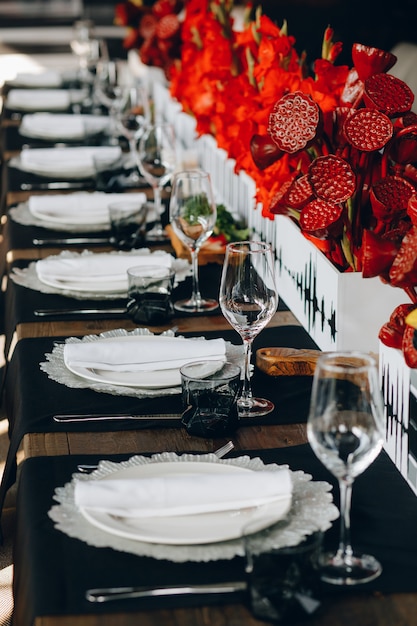 tableware Glasses, flower fork, knife served for dinner in restaurant with cozy interior