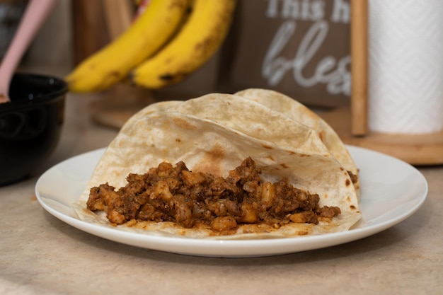 Tacos mexican in a white dish on table in kitchen