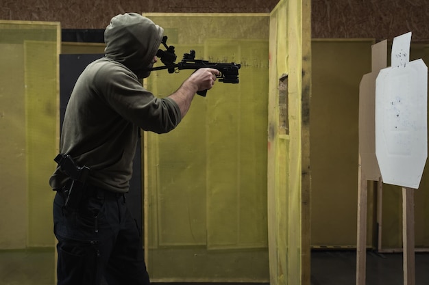 Photo tactical shooting from modern firearms and night vision in a shooting range