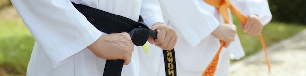 Taekwondo athletes tying belts