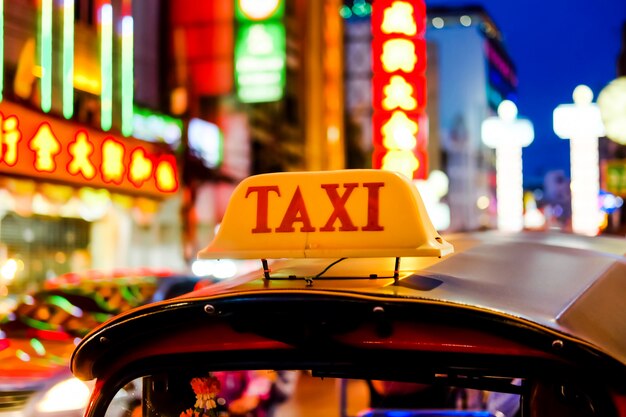 Tag name of Tuk Tuk Car or Taxi Thailand at Yaowarat Road at China town in Bangkok on Night time.