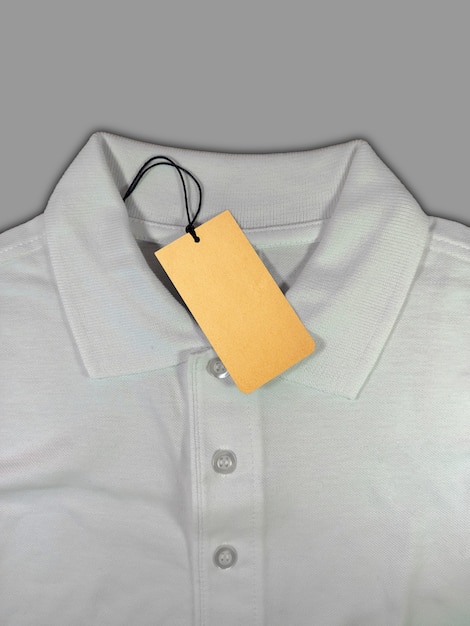 Tag price on white polo shirt isolated on grey background