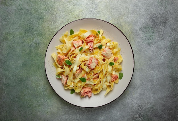 tagliatelle pasta in cream sauce with salmon homemade no people