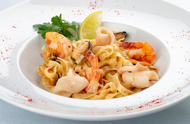 Tagliatelle with seafood Italian traditional dish On a white background