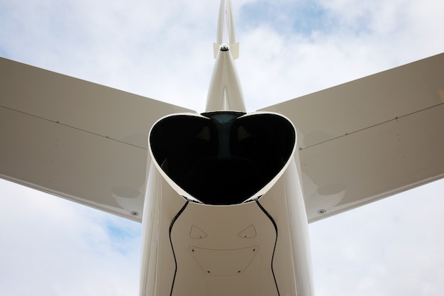 Photo tail of a business jet close-up on background of clouds