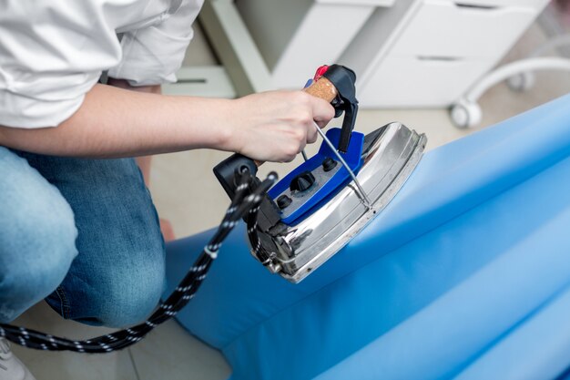 Tailor ironing the fabric.