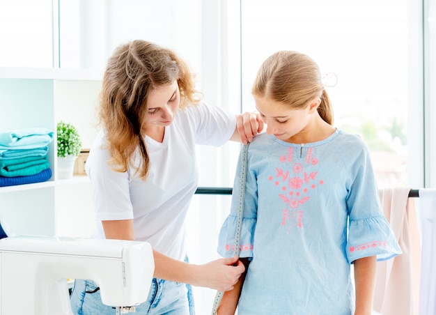 Tailor measuring her client