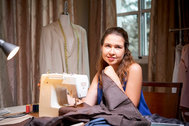 Tailor using sewing machine