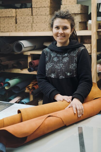 Tailor woman with fabric rolls female textile worker seamstress