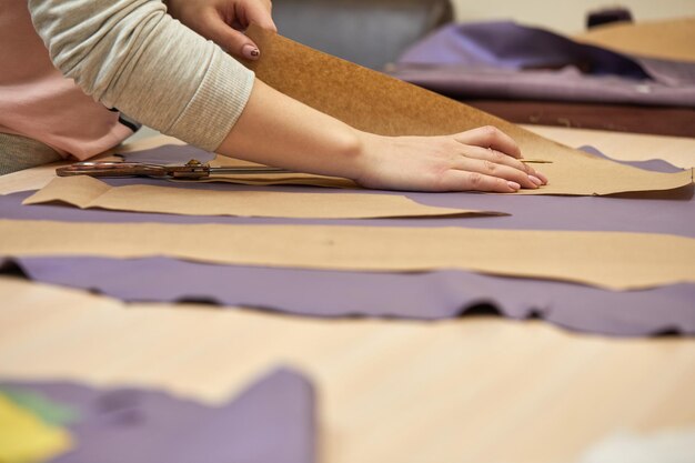 Tailor working at table in atelier