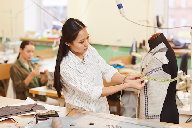 Tailor working with mannequin