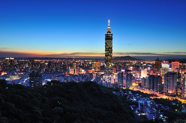 taipei 101 against blue sky in city at dusk