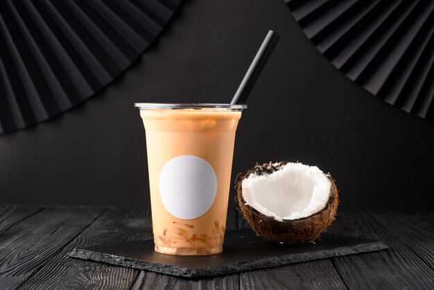 Taiwan milk tea with coconut and mango on wooden background