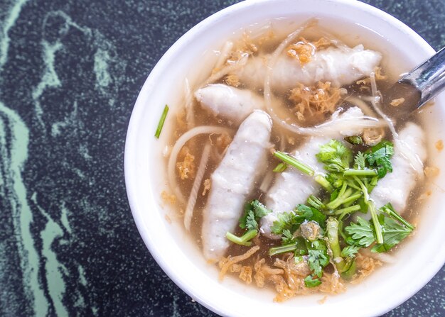 Taiwan's distinctive famous snacks: fish meatball potage soup in a white bowl on stone table, Taiwan Delicacies, Taiwan Street Food