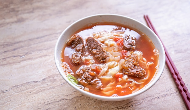 Taiwanese food - Beef noodle ramen with tomato sauce broth in bowl