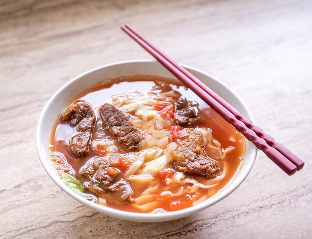 Taiwanese food - Beef noodle ramen with tomato sauce broth in bowl
