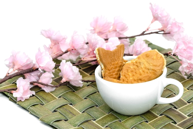 Taiyaki cakes in coffee cup with cherry blossomJapanese confectionery