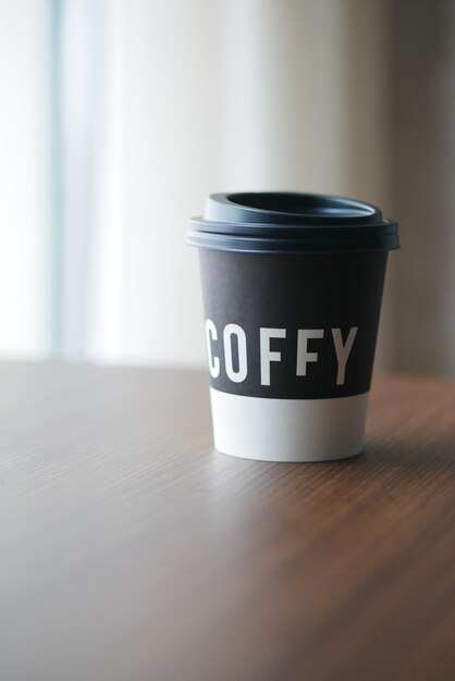 Take away paper coffee cup o on cafe table