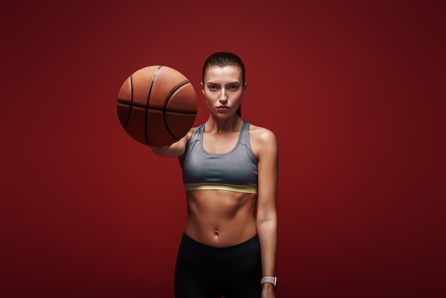 Take care of your body sportswoman with ball standing 