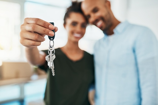 Take the step towards a fresh start Portrait of a young couple holding the keys to their new home