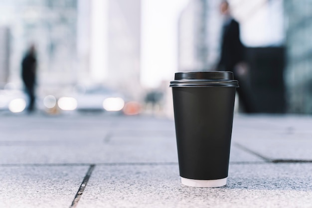 Takeaway coffee in a paper cup Hot drink to go on the background busy city street Paper cup mockup