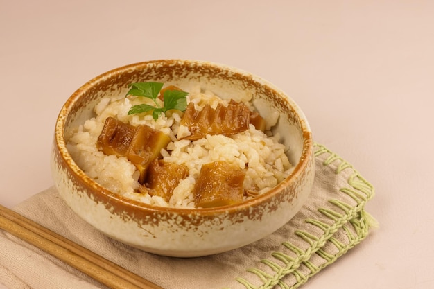 Photo takenoko gohan or bamboo rice is a rice dish cooked in dashi broth with bamboo shoot