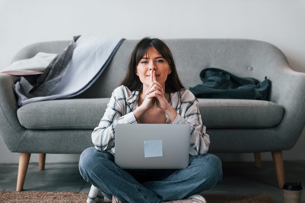 Takes a break Young female freelance worker is indoors in home at daytime