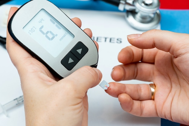 Taking blood from finger for sugar level medical test