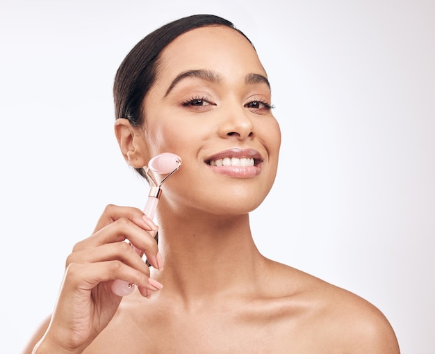 Taking good care of your skin from home has become so easy Studio shot of a young woman holding a derma roller against a white background