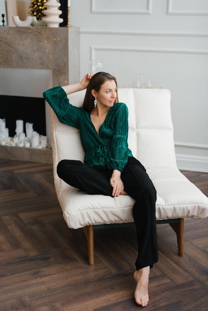 Taking it easy before a big night out Portrait of a beautiful young woman sitting in a chair at home