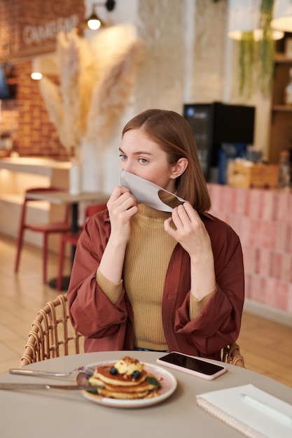 Taking Off Mask In Cafe