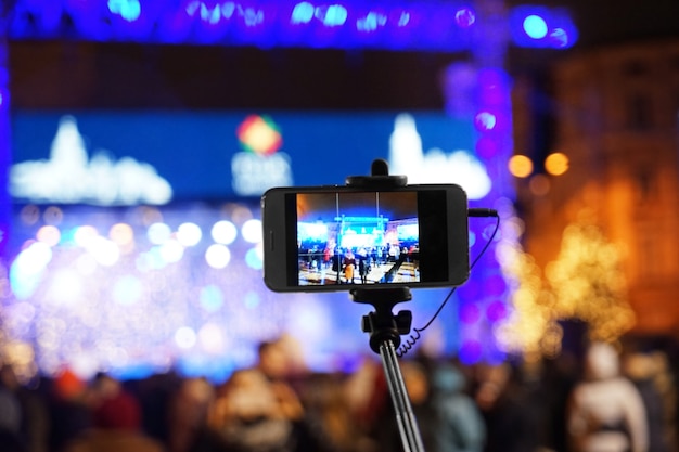 Photo taking photo of people at open air concert