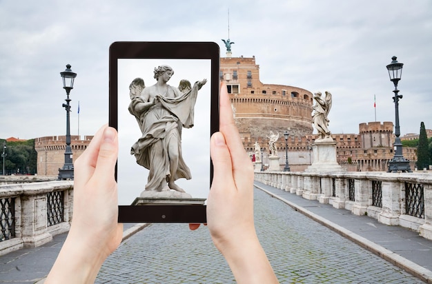 Taking photo of statue on St Angel Bridge Rome