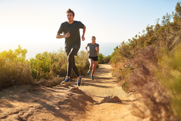 Taking the scenic route to fitness Shot of a young couple out for a trail run