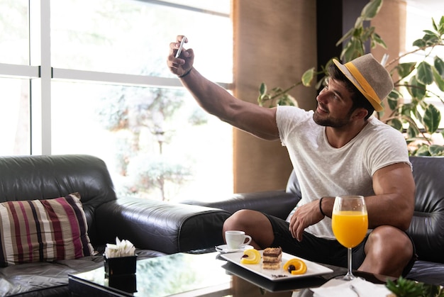 Scattare selfie con il telefono nel bar della hall dell'hotel