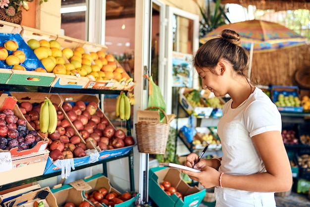 Taking stock Cropped shot of an attractive young woman working at a farm stall