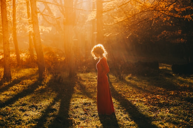 Photo tale. fantastic redhead girl in a mysterious forest