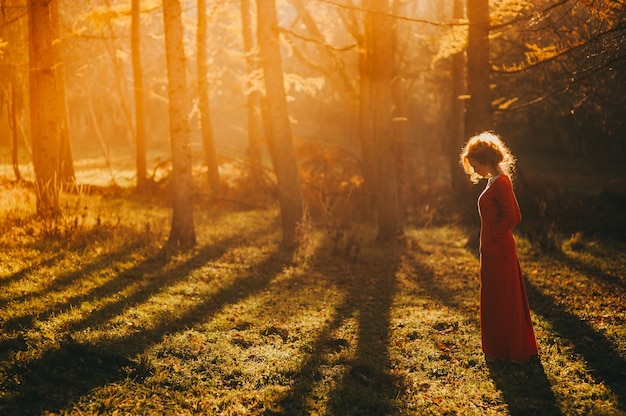 Photo tale. fantastic redhead girl in a mysterious forest