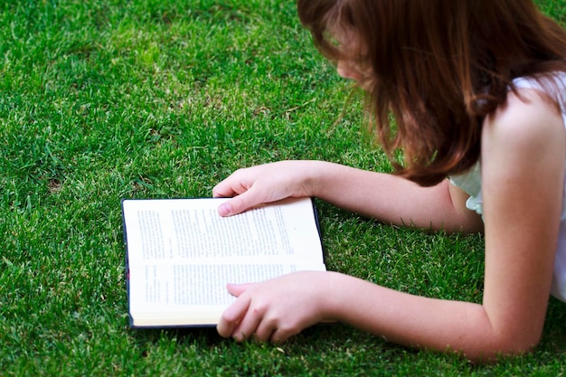 Tale.Young beautiful girl reading a book outdoor