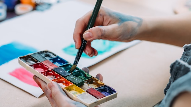 Talent and creativity. Cropped shot of female artist painting abstract artwork with watercolor.