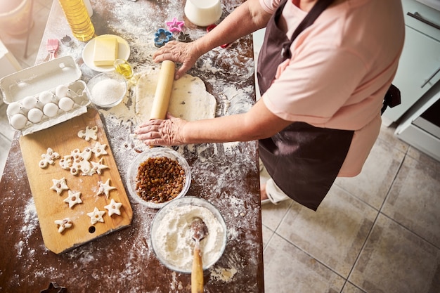 Talented cook making a flat sheet of dough