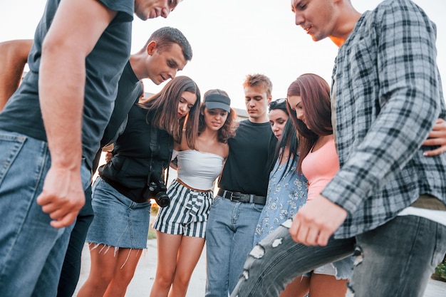 Talking and laughing Group of young cheerful friends having fun together Party outdoors